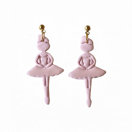 Handmade pink shimmer polymer clay ballerina earrings in tutus hanging from gold ball studs